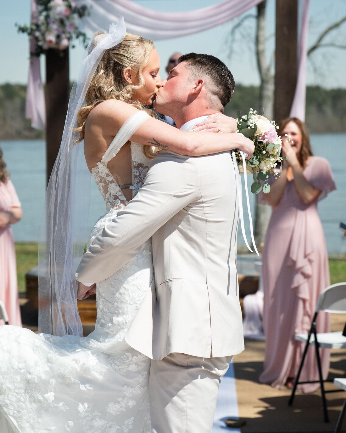 First kiss at an outdoor wedding ceremony